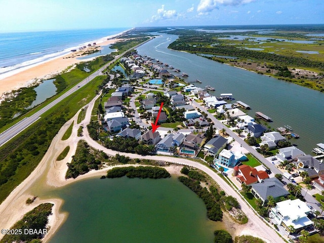 birds eye view of property featuring a view of the beach and a water view