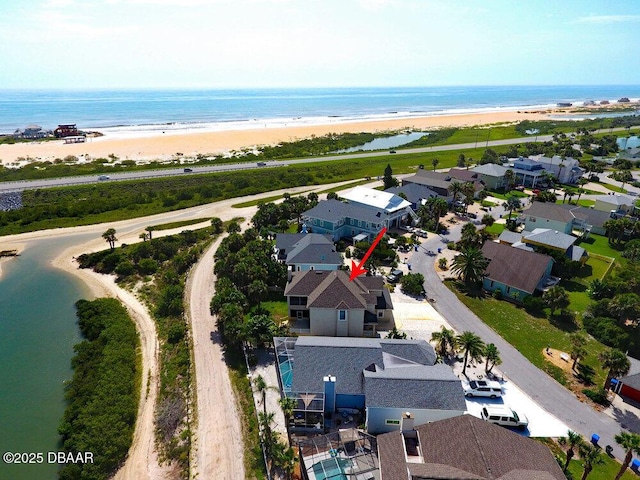 drone / aerial view with a beach view, a water view, and a residential view