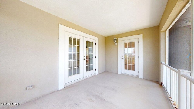 unfurnished sunroom featuring french doors