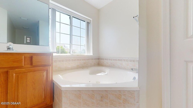 full bath with vanity and a garden tub