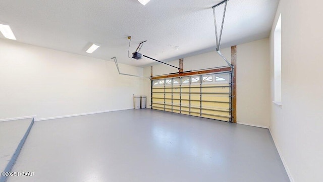 garage featuring a garage door opener and baseboards