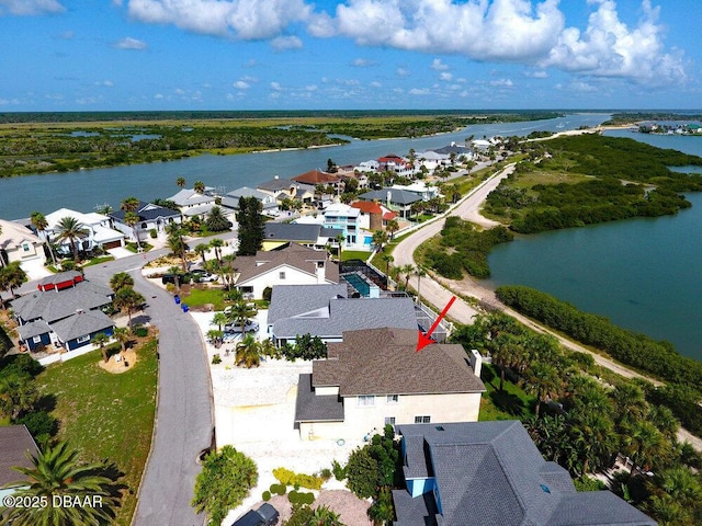 drone / aerial view featuring a residential view and a water view