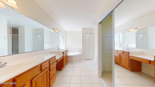 full bath featuring a shower stall, a bath, tile patterned floors, a textured ceiling, and vanity