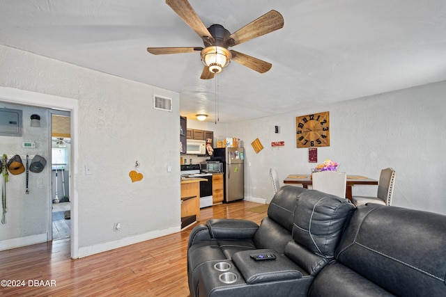 living room with light wood-type flooring and ceiling fan