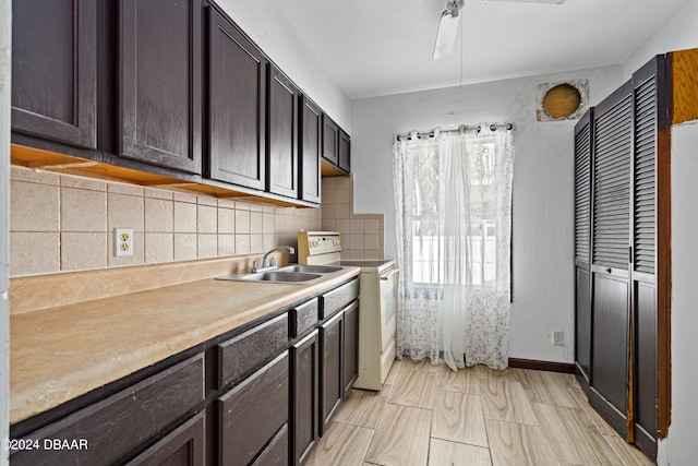 kitchen featuring dark brown cabinetry, sink, backsplash, and electric stove