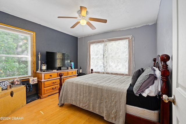 bedroom with hardwood / wood-style flooring and ceiling fan