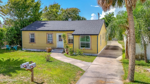 bungalow-style house featuring a front yard