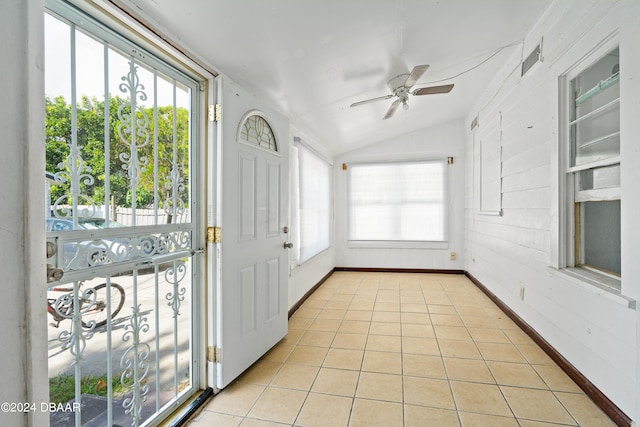 unfurnished sunroom featuring ceiling fan and vaulted ceiling