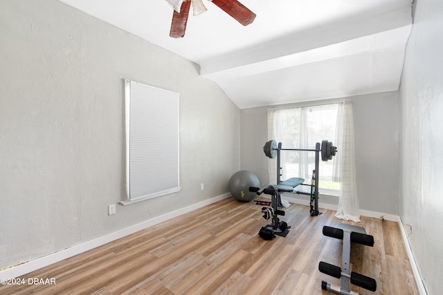 exercise area featuring ceiling fan, vaulted ceiling, and light hardwood / wood-style floors