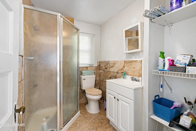 bathroom with walk in shower, vanity, tile walls, and toilet