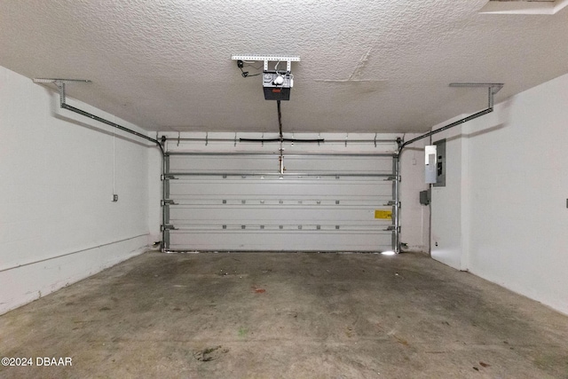 garage with electric panel and a garage door opener