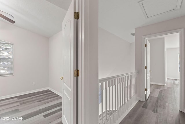 hallway with hardwood / wood-style flooring