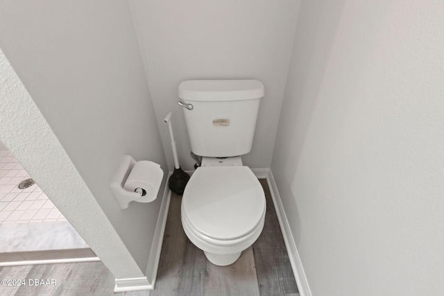 bathroom featuring toilet and hardwood / wood-style flooring