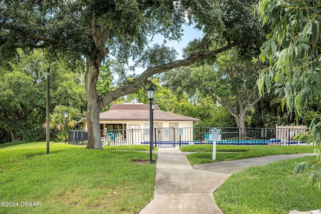 surrounding community featuring a lawn and a swimming pool