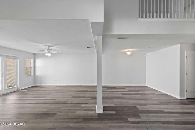 unfurnished living room with ceiling fan and dark wood-type flooring