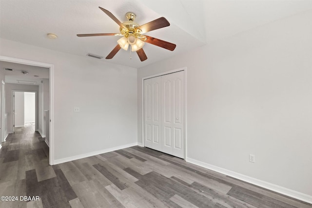 spare room with ceiling fan and dark hardwood / wood-style flooring