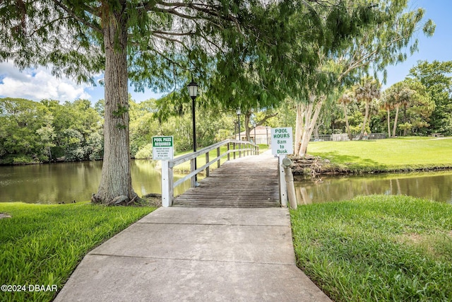 view of community with a water view and a yard