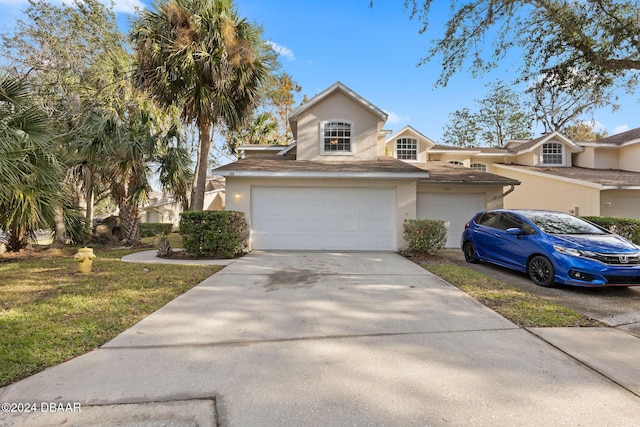 view of front of home featuring a garage and a front lawn