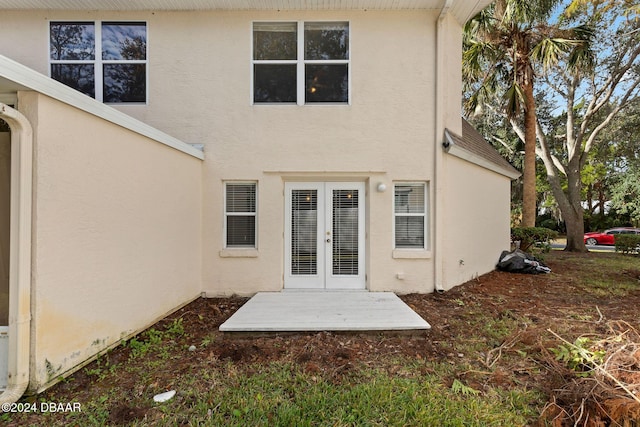 rear view of house featuring french doors