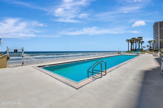 view of pool with a water view