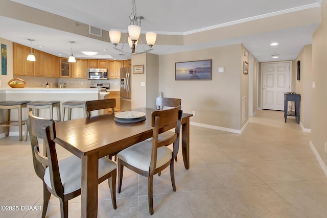 dining space with light tile patterned floors, crown molding, and a chandelier