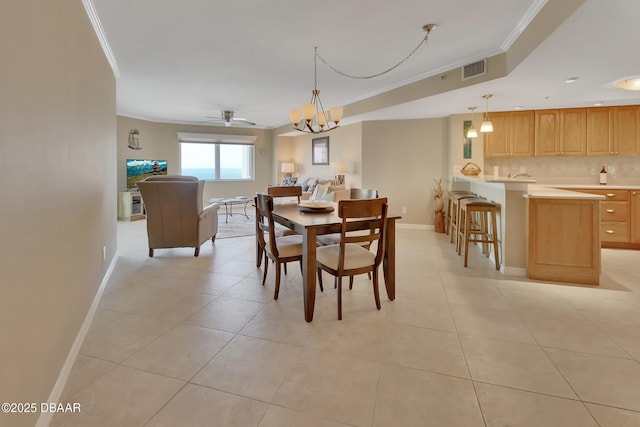 dining space featuring light tile patterned flooring, ornamental molding, and ceiling fan with notable chandelier