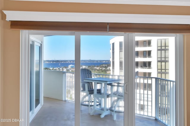 interior space with concrete flooring, french doors, and a water view