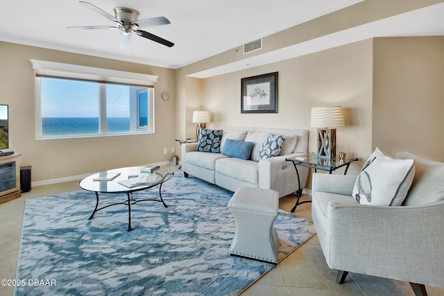 tiled living room with a water view, ceiling fan, and crown molding