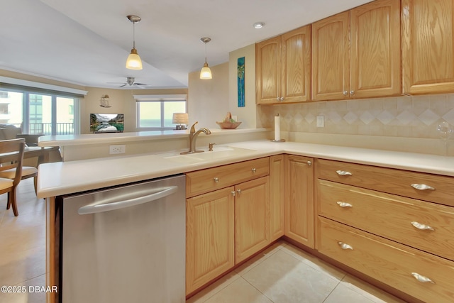 kitchen featuring pendant lighting, sink, kitchen peninsula, and dishwasher