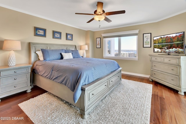 bedroom with ornamental molding, dark hardwood / wood-style floors, and ceiling fan