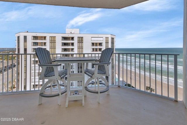 balcony with a water view and a beach view