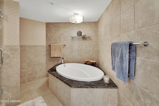 bathroom featuring tile walls, tile patterned floors, and separate shower and tub