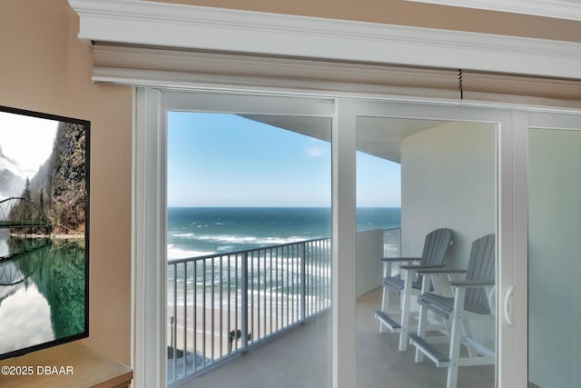 balcony featuring a water view and a beach view