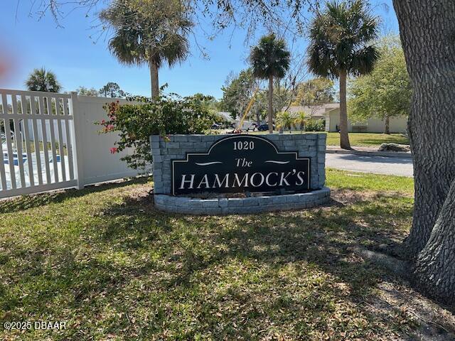 community / neighborhood sign featuring fence