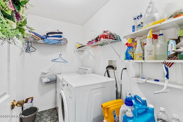 clothes washing area with a textured ceiling and separate washer and dryer