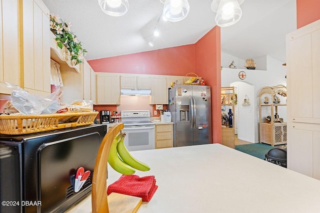 kitchen featuring a textured ceiling, vaulted ceiling, electric stove, and stainless steel refrigerator with ice dispenser