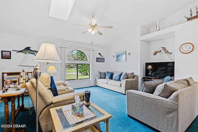 living room featuring ceiling fan, carpet flooring, and vaulted ceiling with skylight