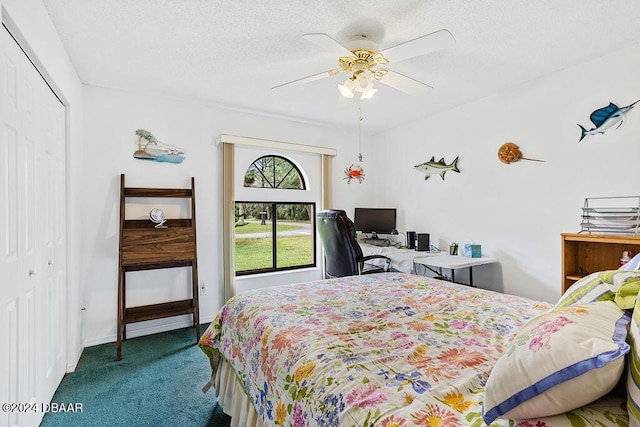 carpeted bedroom featuring a textured ceiling, ceiling fan, and a closet