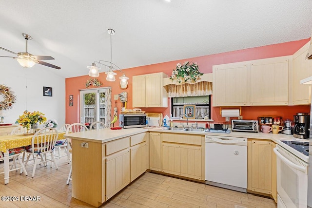 kitchen with sink, white appliances, ceiling fan, kitchen peninsula, and pendant lighting