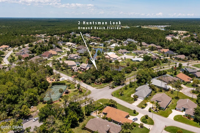 aerial view featuring a view of trees and a residential view