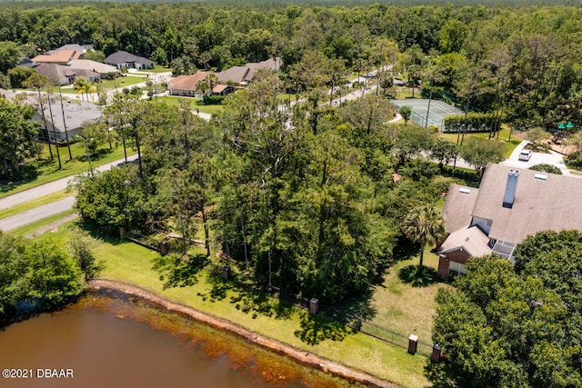 aerial view featuring a wooded view and a water view