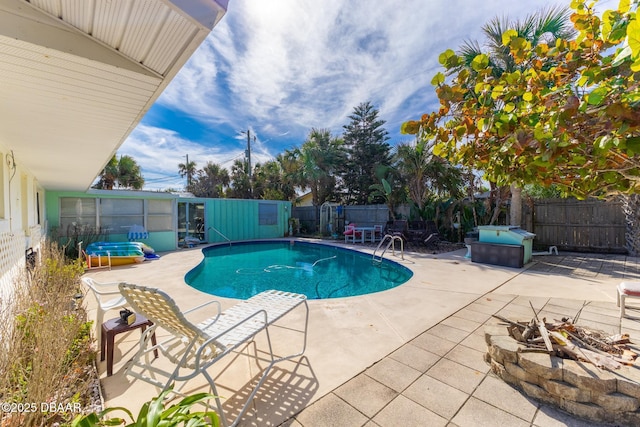 view of pool featuring a fire pit, a patio, and a hot tub