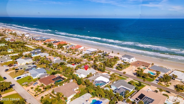 aerial view with a water view and a view of the beach