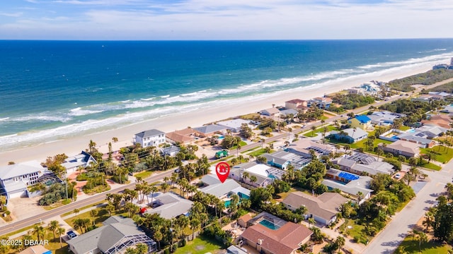 aerial view with a water view and a beach view