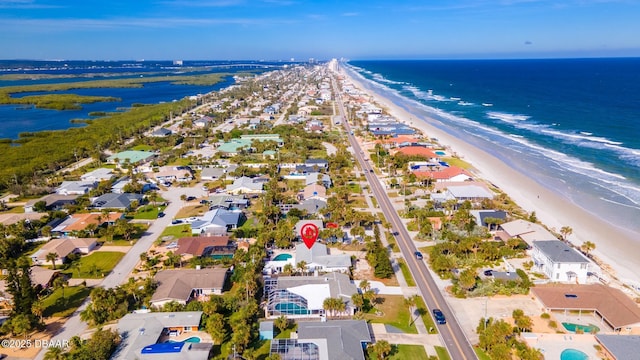 bird's eye view with a water view and a view of the beach