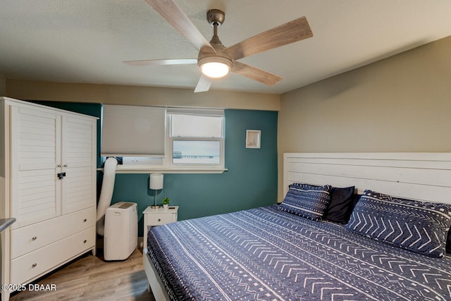 bedroom with ceiling fan and light hardwood / wood-style floors