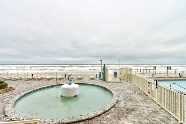 view of property's community with a swimming pool and a patio