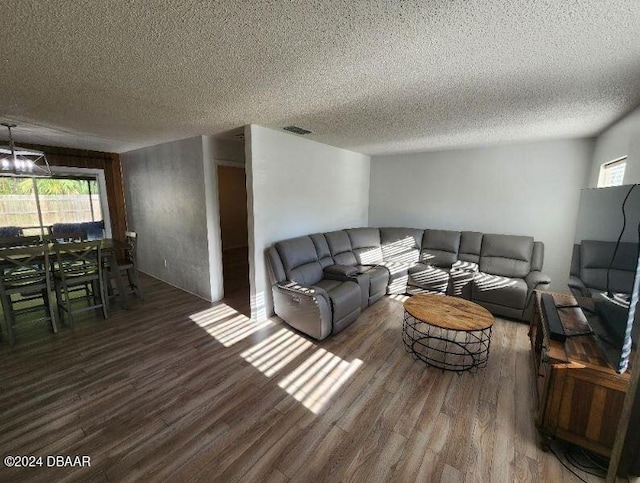 living room featuring dark hardwood / wood-style flooring and a textured ceiling