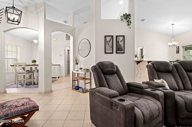 living room with high vaulted ceiling and light tile patterned floors