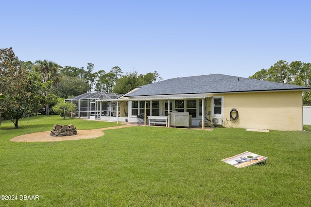 10 Pointing Pl, Palm Coast, FL 32164 - back of property with a fire pit, a patio area, a shingled roof, a jacuzzi, and a lawn